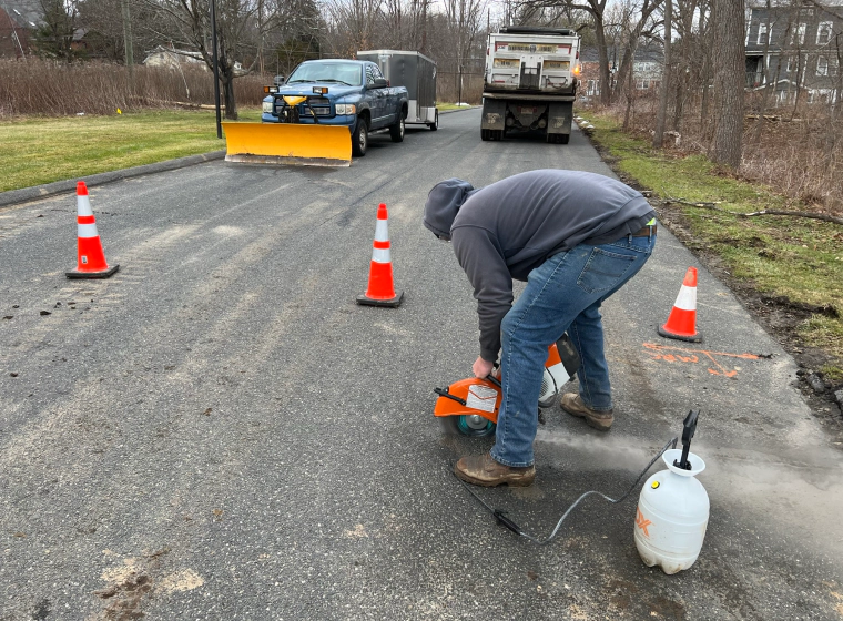 constructor cutting the floor of the road on windsor locks ct